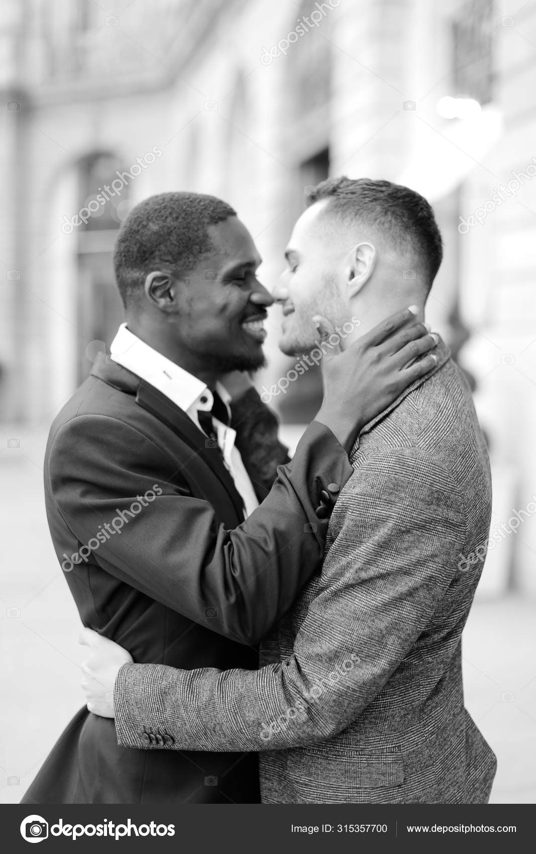 Black and white photo of happy afro american gay hugging caucasian photo