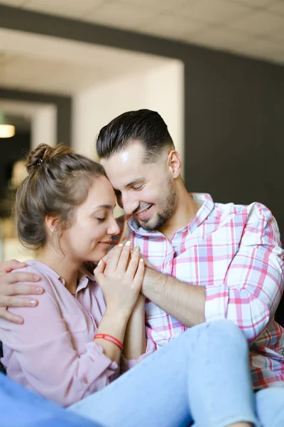 Young pretty boy hugging gilfriend wearing jeans. — Stock Photo, Image