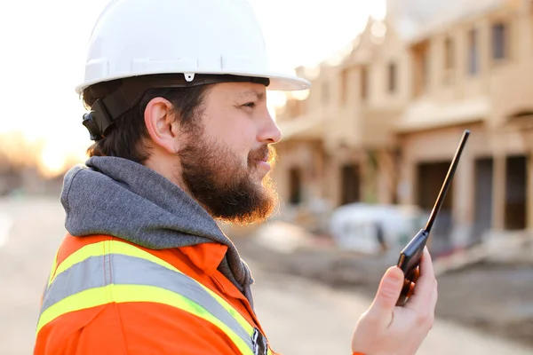 Retrato do capataz europeu falando por walkie talkie no canteiro de obras . — Fotografia de Stock