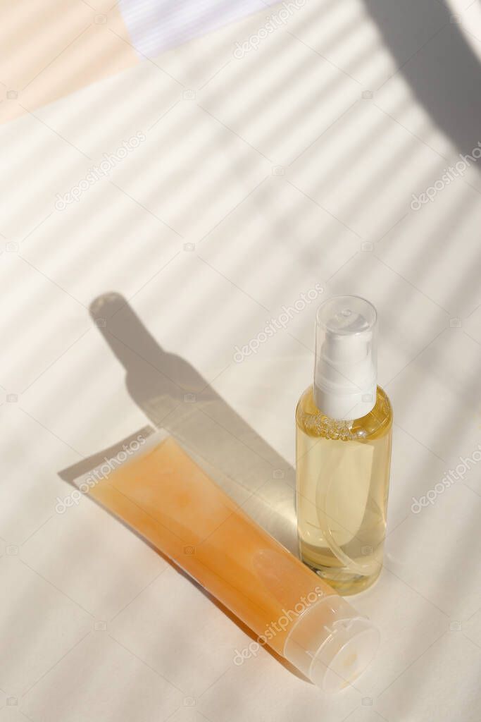 Spray bottle of lotion and natural cream for face in light background with copy space.