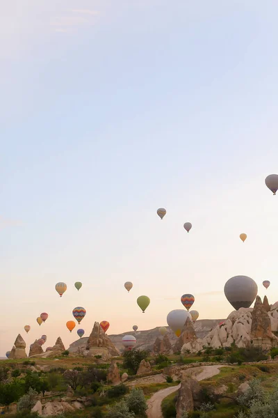 Many colorful hot air balloons flying over Cappadocia rocks in Turkey. — Stock Photo, Image