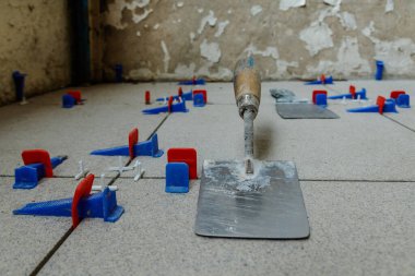 Plastik takozlu döşeme sistemi. Döşeme kiremitlerinin kurulumu. Seramik fayanslar ve araçlar.