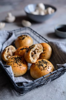 Baked buns stuffed with mushrooms and cheese, studded with black cumin clipart