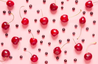 Pembe arka planda kiraz ve yaban mersini. Düz yatıyordu, üstten bak. - Resim