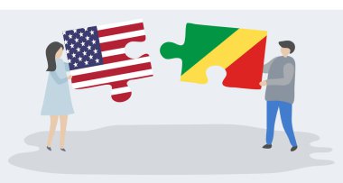 Amerikan ve Kongo bayrakları yla iki bulmaca tutan çift. Amerika Birleşik Devletleri ve Kongo Cumhuriyeti ulusal sembolleri birlikte.