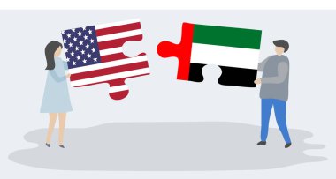 Amerikan ve Emirian bayrakları ile iki bulmaca parçaları tutan çift. Amerika Birleşik Devletleri ve Birleşik Arap Emirlikleri ulusal sembolleri birlikte.
