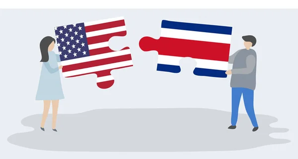 Para Trzyma Dwa Kawałki Puzzli Amerykańskich Kostarykańskimi Flagami Stany Zjednoczone — Wektor stockowy