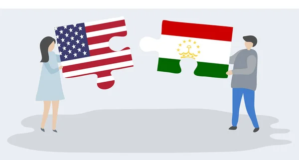 Para Trzyma Dwa Kawałki Puzzli Amerykańskich Tadżycki Flagi Stany Zjednoczone — Wektor stockowy