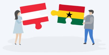 Avusturya ve Gana bayrakları ile iki bulmaca parçaları tutan çift. Avusturya ve Gana ulusal sembolleri birlikte.