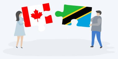 Çift Kanada ve Tanzanya bayrakları ile iki bulmaca parçaları tutan. Kanada ve Tanzanya ulusal sembolleri birlikte.