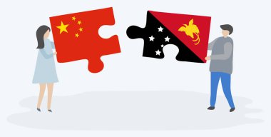 Çift Çin ve Papuan bayrakları ile iki bulmaca parçaları tutan. Çin ve Papua Yeni Gine ulusal sembolleri birlikte.