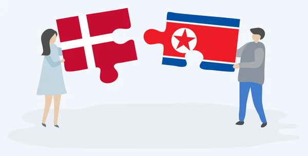 Pareja Sosteniendo Dos Piezas Rompecabezas Con Banderas Danesas Norcoreanas Dinamarca — Archivo Imágenes Vectoriales