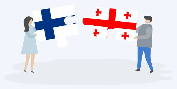 一对夫妇拿着两块带有芬兰和格鲁吉亚国旗的拼图 芬兰和格鲁吉亚国家符号在一起 — 图库矢量图片