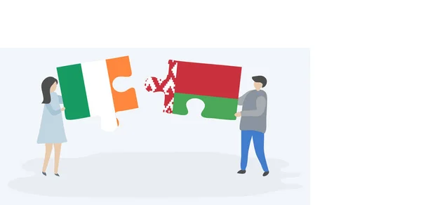 一对夫妇拿着两个拼图片与爱尔兰和白俄罗斯国旗 爱尔兰和白俄罗斯国家符号在一起 — 图库矢量图片