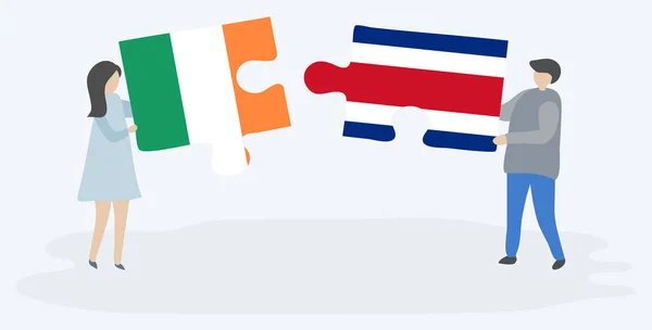 Para Trzyma Dwa Kawałki Puzzli Irlandzkimi Kostarykańską Banderą Symbole Narodowe — Wektor stockowy