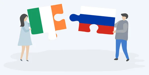 Para Trzyma Dwa Kawałki Puzzli Irlandzkimi Rosyjskimi Flagami Symbole Narodowe — Wektor stockowy