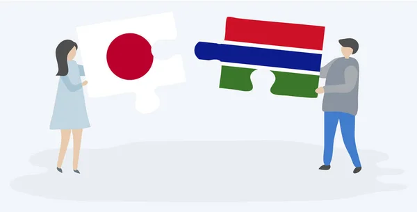 一对夫妇拿着两个拼图片与日本和冈比亚国旗 日本和冈比亚国家符号在一起 — 图库矢量图片