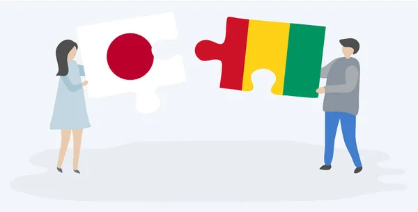 Ζευγάρι Που Κρατά Δύο Κομμάτια Παζλ Ιαπωνικά Και Γουινέα Σημαίες — Διανυσματικό Αρχείο
