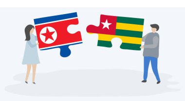 Kuzey Kore ve Togo bayrakları ile iki bulmaca parçaları tutan çift. Kuzey Kore ve Togo ulusal sembolleri birlikte.