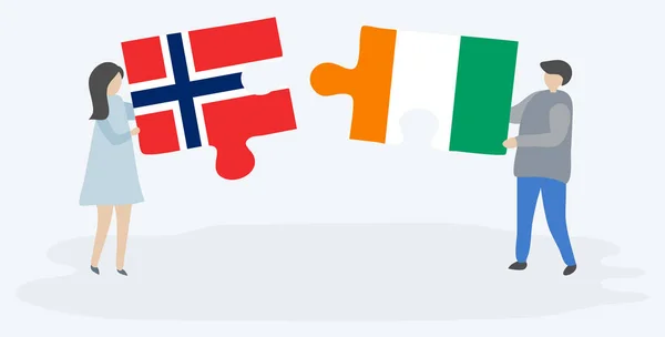 Ζευγάρι Που Κρατά Δύο Κομμάτια Παζλ Σημαίες Νορβηγικού Και Ελεφαντοστού — Διανυσματικό Αρχείο