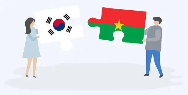 Para Trzyma Dwa Kawałki Puzzli Korei Południowej Flagi Burkinabe Korea — Wektor stockowy