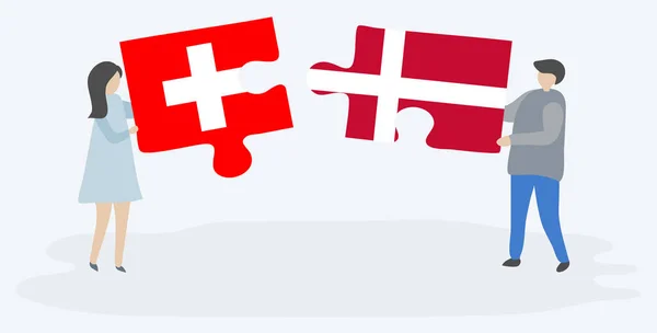 Пара Держащая Две Головоломки Швейцарскими Датскими Флагами Швейцария Дания Вместе — стоковый вектор