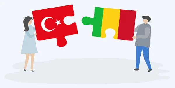 一对夫妇拿着两个拼图片 上面挂着土耳其和马里国旗 土耳其和马里国家符号在一起 — 图库矢量图片