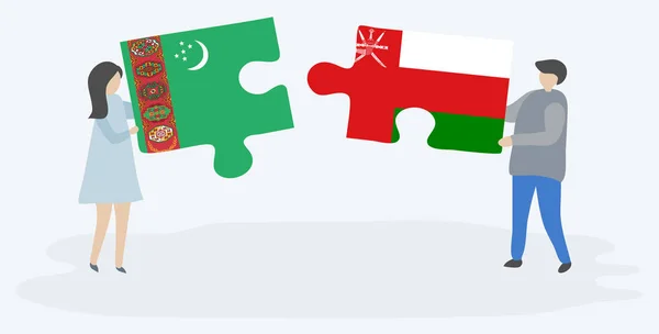 トルクメンとオマーンの旗を持つ2つのパズルピースを保持しているカップル トルクメニスタンとオマーンの国のシンボル — ストックベクタ