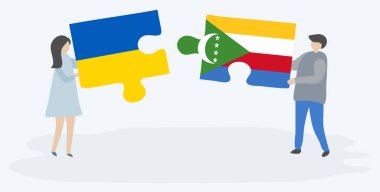 Çift Ukrayna ve Comoran bayrakları ile iki bulmaca parçaları tutan. Ukrayna ve Komorlar ulusal sembolleri birlikte.