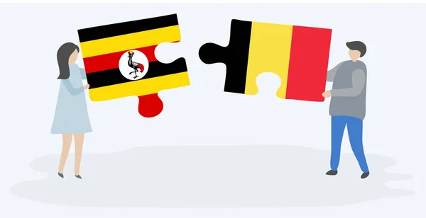 Para Trzyma Dwa Kawałki Puzzli Ugandy Belgijskich Flag Symbole Narodowe — Wektor stockowy