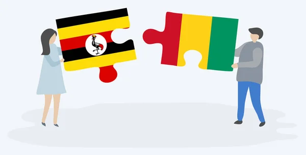 Para Trzyma Dwa Kawałki Puzzli Ugandy Gwinejów Flagi Symbole Narodowe — Wektor stockowy