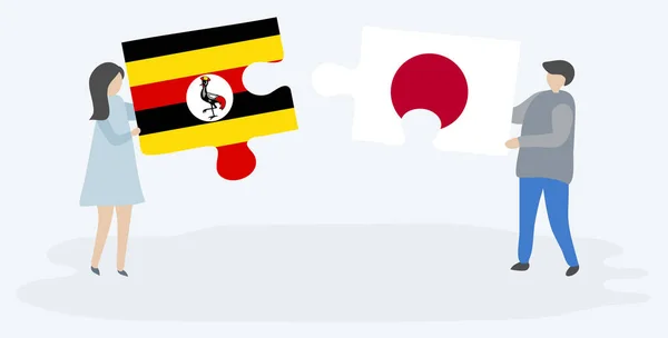 Para Trzyma Dwa Kawałki Puzzli Ugandy Japońskich Flag Symbole Narodowe — Wektor stockowy