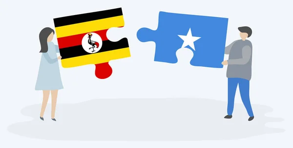 Para Trzyma Dwa Kawałki Puzzli Ugandy Somalii Flagi Symbole Narodowe — Wektor stockowy