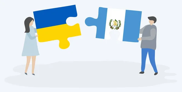 夫妇拿着两个拼图片与乌克兰和危地马拉国旗 乌克兰和危地马拉国家符号在一起 — 图库矢量图片