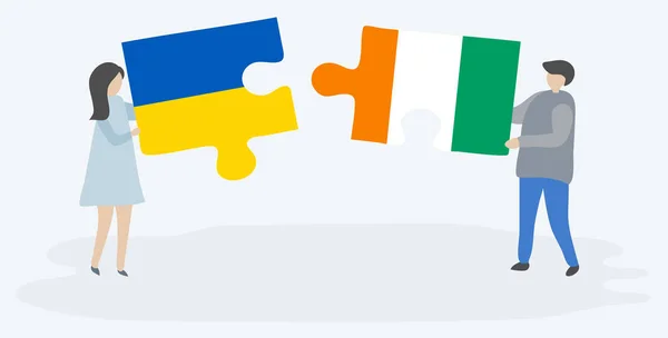 Paar Mit Zwei Puzzleteilen Mit Ukrainischen Und Ivorischen Flaggen Nationale — Stockvektor