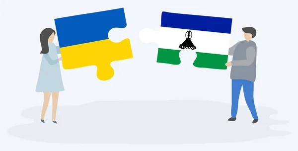 夫妇拿着两个拼图片与乌克兰和巴索托国旗 乌克兰和莱索托国家符号在一起 — 图库矢量图片