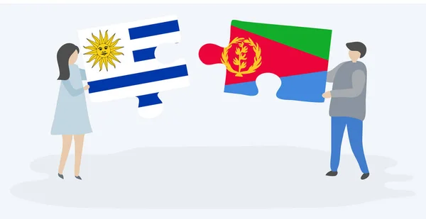 Para Trzyma Dwa Kawałki Puzzli Urugwaju Erytrean Flagi Symbole Narodowe — Wektor stockowy
