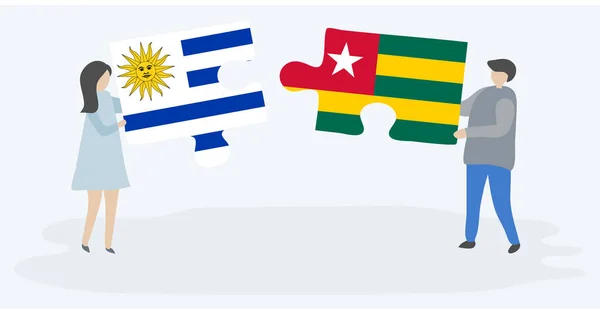 Para Trzyma Dwa Kawałki Puzzli Urugwajskim Togolese Flagi Urugwaj Togo — Wektor stockowy