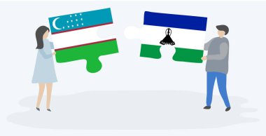 Çift Özbek ve Basotho bayrakları ile iki bulmaca parçaları tutan. Özbekistan ve Lesotho ulusal sembolleri birlikte.