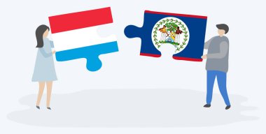 Lüksemburg ve Belizean bayrakları ile iki bulmaca parçaları tutan çift. Lüksemburg ve Belize ulusal sembolleri birlikte.