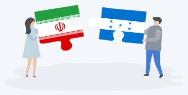 İran ve Honduras bayrakları ile iki bulmaca parçaları tutan çift. İran ve Honduras ulusal sembolleri birlikte.