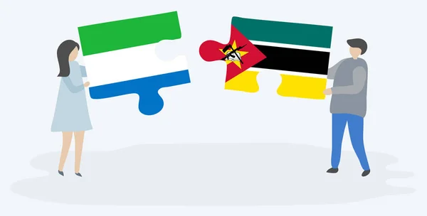 Dvojice Drží Dvě Skládanky Vlajkami Sierra Leonean Mosambiků Národní Symboly — Stockový vektor
