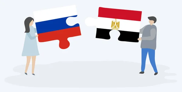 一对夫妇拿着两个拼图 上面挂着俄罗斯和埃及国旗 俄罗斯和埃及国家符号在一起 — 图库矢量图片