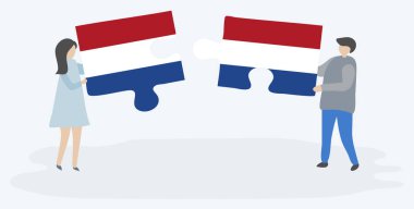 Hollanda ve Hollanda bayrakları ile iki bulmaca parçaları tutan çift. Hollanda ve Hollanda ulusal sembolleri birlikte.