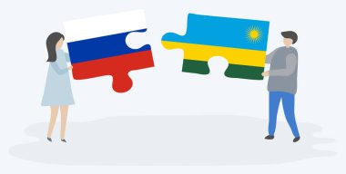 Rus ve Ruanda bayrakları ile iki bulmaca parçaları tutan çift. Rusya ve Ruanda ulusal sembolleri birlikte.