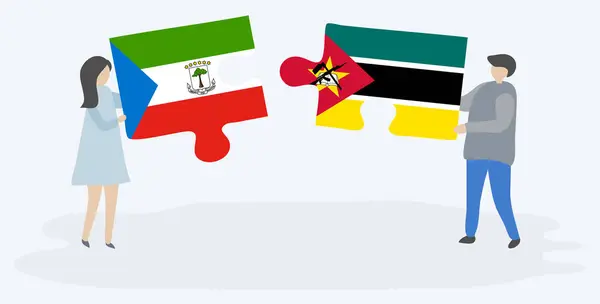 一对夫妇拿着两块拼图 上面挂着赤道几内亚和莫桑比克国旗 赤道几内亚和莫桑比克国家符号在一起 — 图库矢量图片