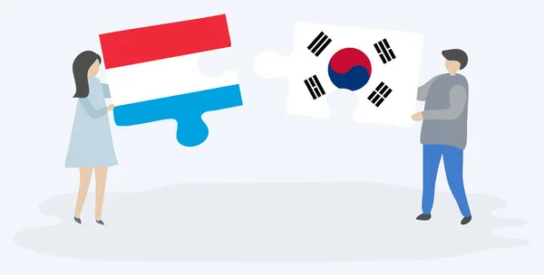 Para Trzyma Dwa Kawałki Puzzli Luksemburskimi Południowokoreańskimi Flagami Symbole Narodowe — Wektor stockowy