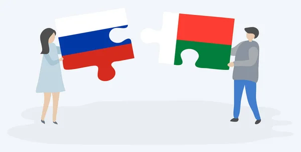 Couple Tenant Deux Pièces Puzzles Avec Des Drapeaux Russes Malgaches — Image vectorielle