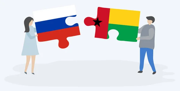 一对夫妇拿着两块拼图 上面挂着俄罗斯和比绍 几内亚国旗 俄罗斯和几内亚比绍国家象征在一起 — 图库矢量图片