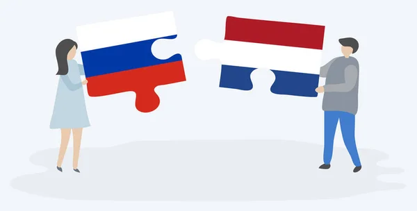 Paar Houden Twee Puzzels Stukken Met Russische Nederlandse Vlaggen Rusland — Stockvector